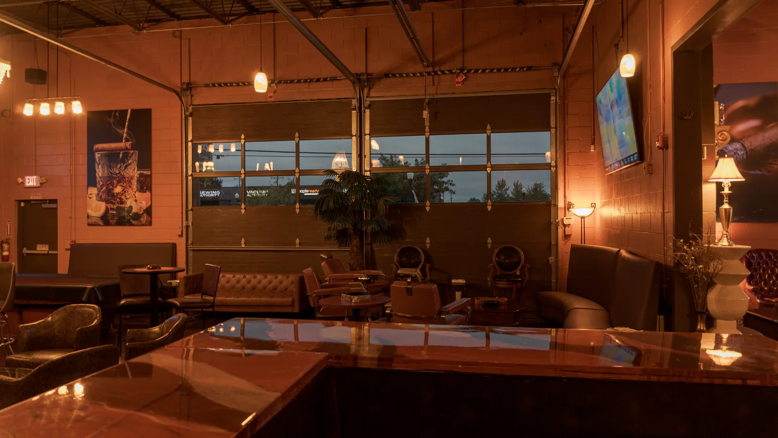 Warm pendant lights and leather seating at The Bay, photographed by Jalil Hay